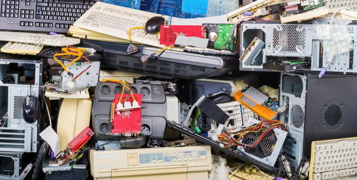E-waste heap of used computer parts such as printers, chassis, keyboards and mice