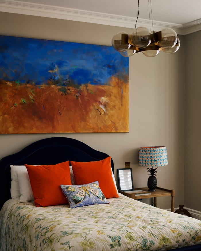 A bed by Love Your Home, lampshades from Anthropologie and side tables by Oka in one of the bedrooms