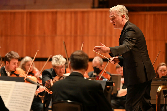 A conductor leads an orchestra