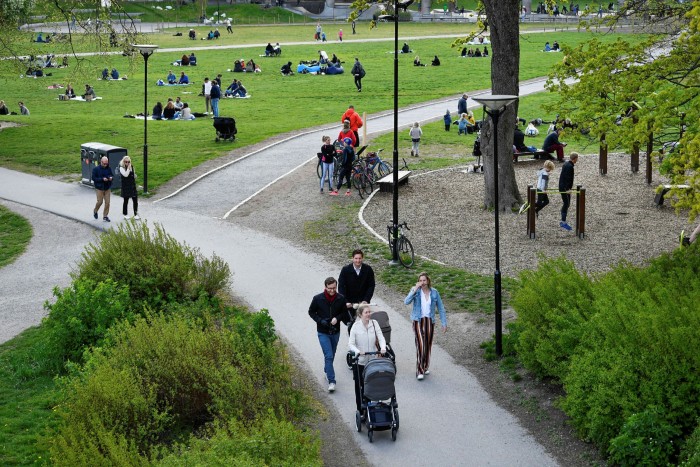 People stroll in Ralambshovsparken park in central Stockholm