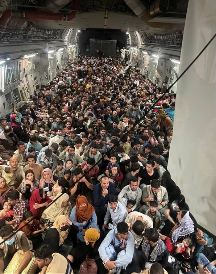 Afghans crowding on to a US C-17 Globemaster III flying 640 evacuees to Qatar, August 15