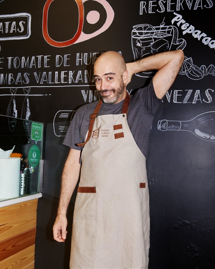  Roger, Latazo’s owner, standing in front of a blackboard