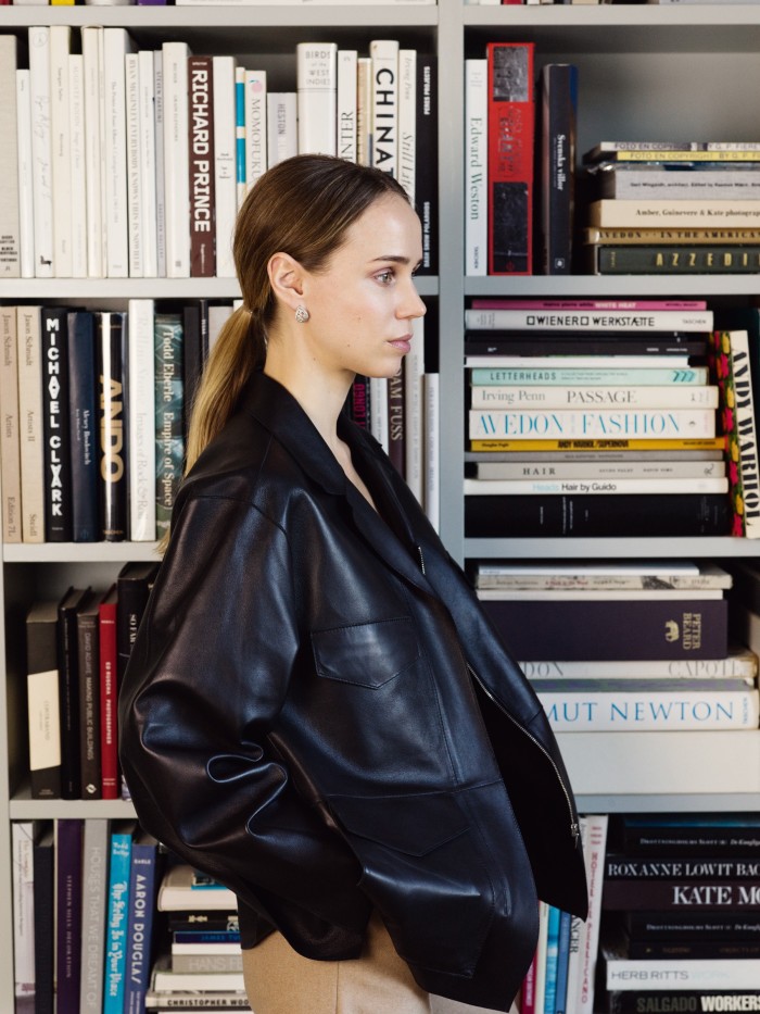 Kling in her Stockholm home wearing her Totême leather jacket and a pair of vintage earrings from Kaplans auction house