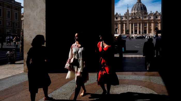 Women walk in Rome near the Vatican