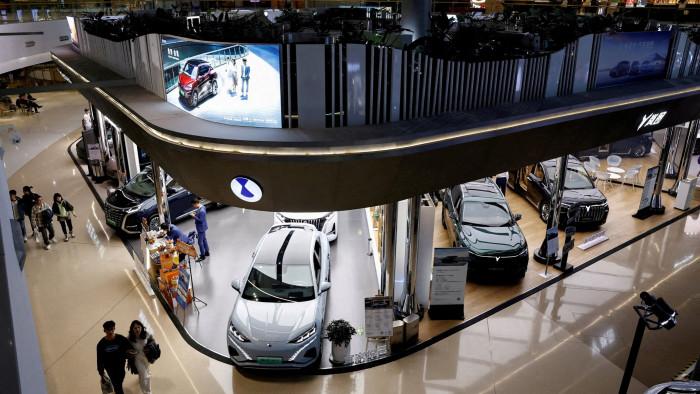 Electric vehicles are displayed at a shopping mall in Beijing, China