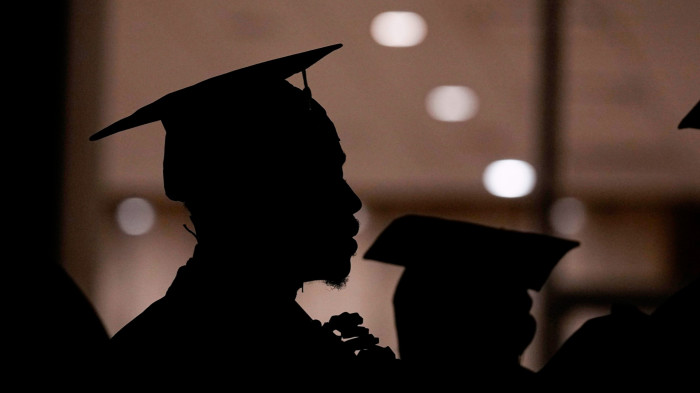 A student lines up before a college commencement ceremony