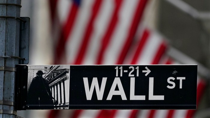 Wall Street sign and a US flag