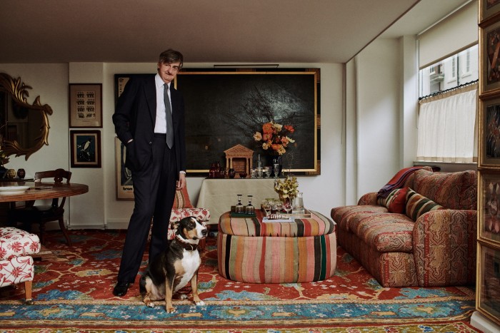Robin Birley in his Mayfair studio with his dog Peg – to his left is an array of glassware from his collection 