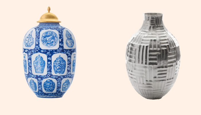 Two vases are shown against a cream background. The one on the left, topped with a golden lid, is rounder and decorated with blue-and-white ceramics-inspired images of plates and vases. The one on the right is white, featuring geometrical, grid-like motifs.