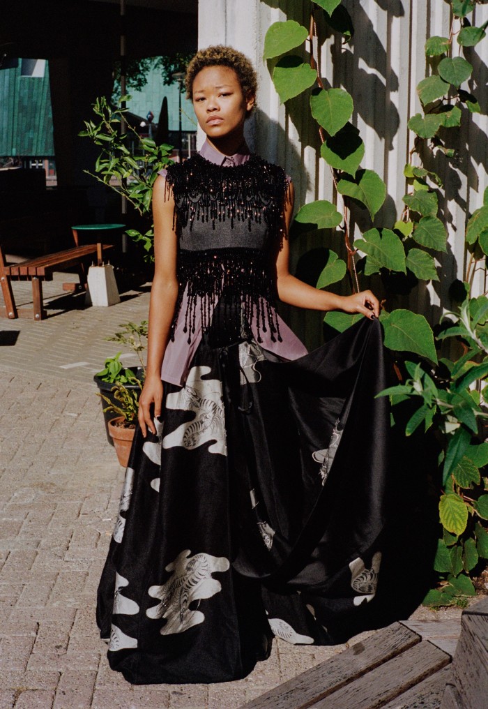Kaya was born in New York and came to Amsterdam aged seven. Now 18, she has recently finished high school, sings, plays piano and is currently preparing to go to art school. Prada wool and bead embroidered top, £4,150, and organza cotton shirt, £605. Loewe wool/silk satin skirt, £5,450