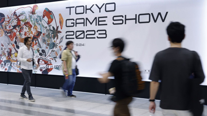 Attendees walk past a sign for the Tokyo Game Show in Chiba, Japan on September 21 2023