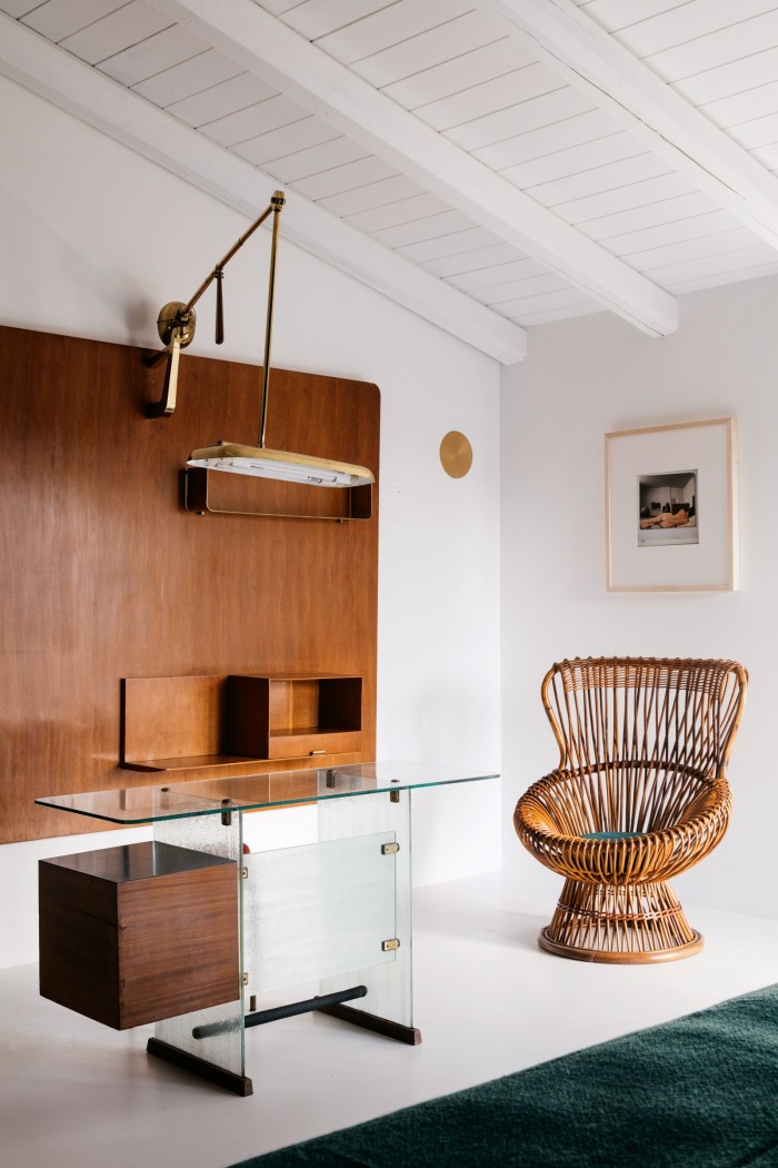 In one room a 1939 Gio Ponti desk and 1946 shelving unit are juxtaposed with a 1970 print by Italian photographer Ugo Mulas and a 1950s-’60s Franco Albini cane chair