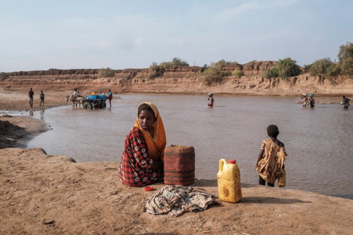 A girl looks on as she sits on the shore of the Shabelle river in the city of Gode, Ethiopia