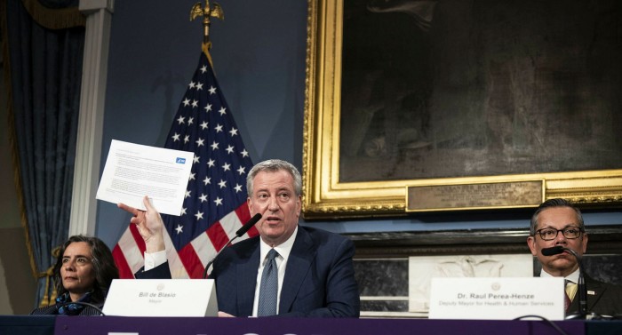 Bill de Blasio, mayor of New York, centre, and Oxiris Barbot, then public health commissioner, left, at a press conference in New York, on March 13