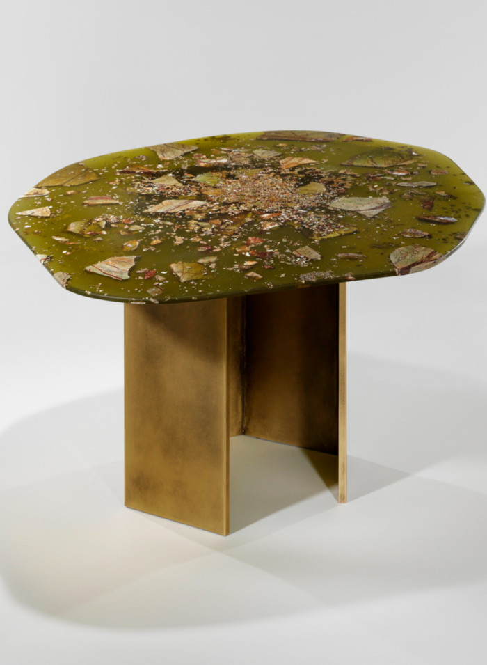 A large swampy-green resin top on a bronze hexagonal stand