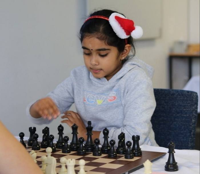 Young chess player Bodhana Sivanandan at the board 