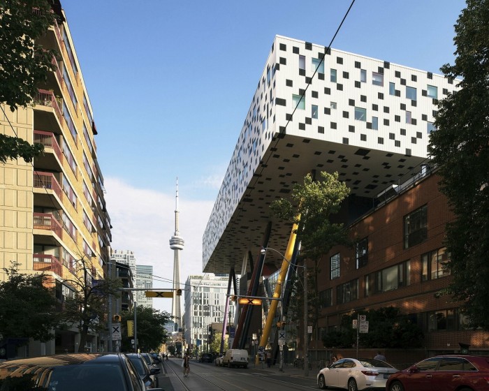 The Rosalie Sharp Centre for Design: a giant white rectangular box on coloured steel legs. The CN Tower can be seen in the distance behind it