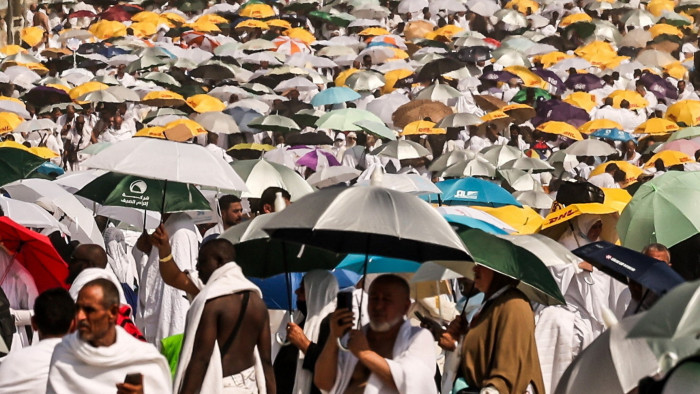 Muslim pilgrims use umbrellas to shade themselves from the sun as they arrive at the base of Mount Arafat during the annual hajj pilgrimage 