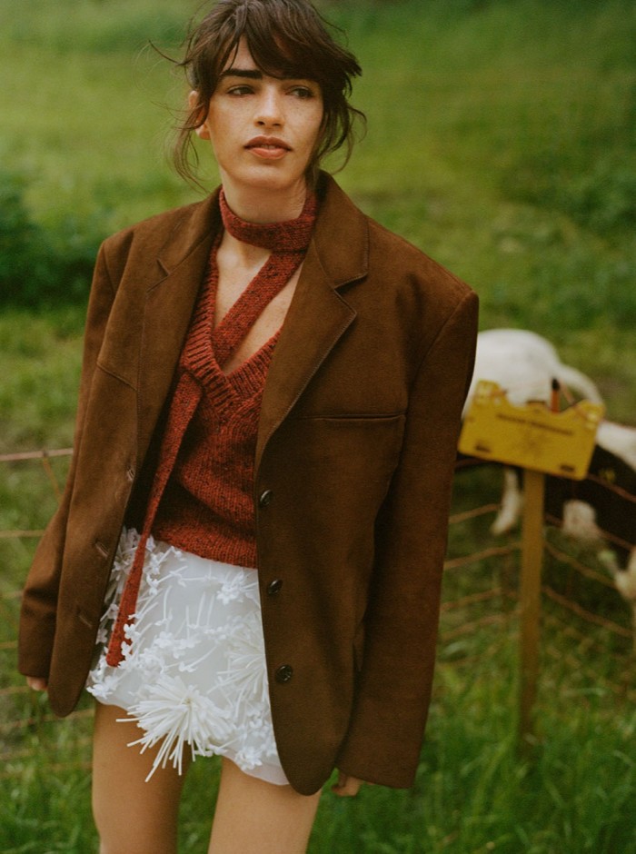 Esin wears Prada suede jacket, £4,350, embroidered satin organza skirt, £5,100, and brushed leather pumps, £1,070. Saks Potts wool knit jumper, £350. Falke wool socks, £30