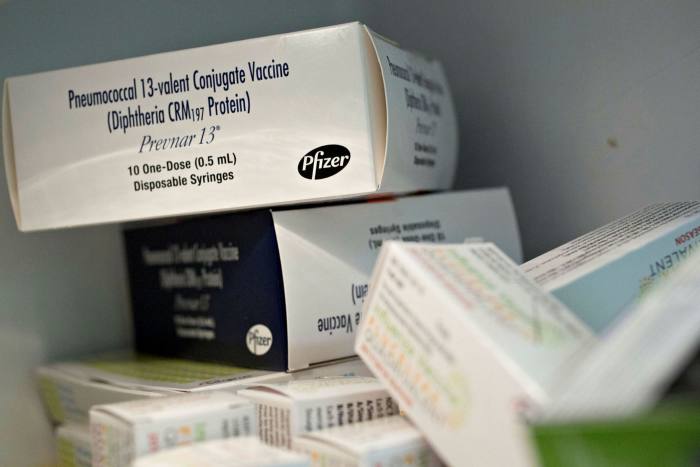 A box of Pfizer Inc. Prevnar 13 vaccine syringes sit inside a refrigerator