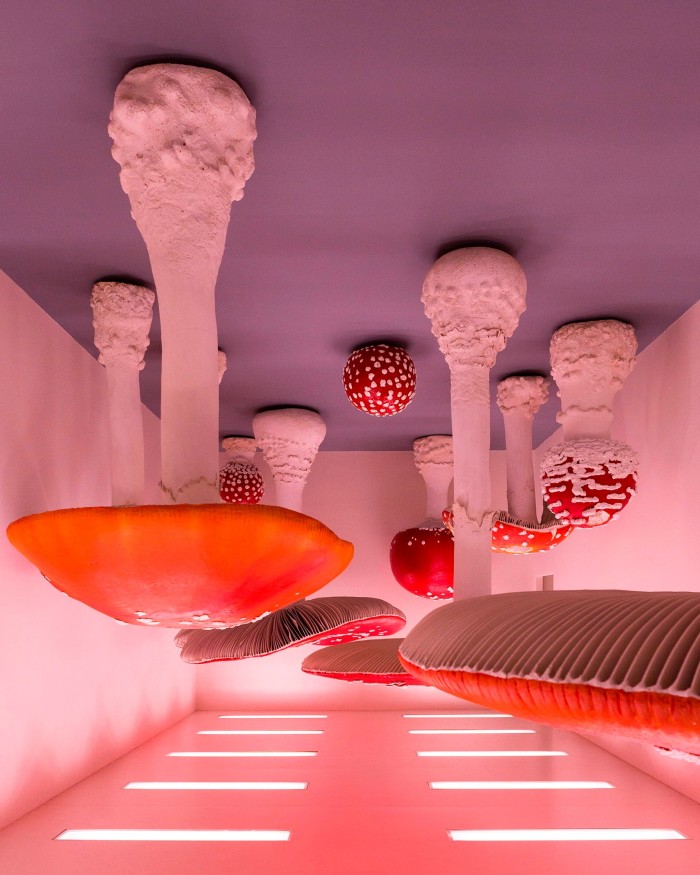 ‘The Upside Down Mushroom Room’: giant red and white mushrooms hanging by their stalks from the ceiling in an installation by artist Carsten Höller at Milan’s Prada Foundation