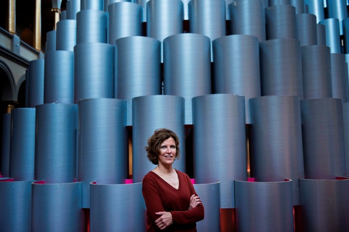 American architect, Jeanne Gang standing in front of cylinders