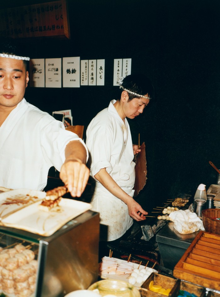 Chefs cook chicken skewers at Toriyoshi Ginza