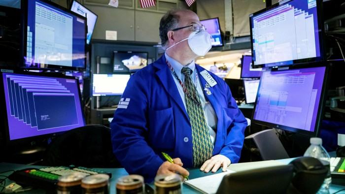 A trader wearing a mask at the New York Stock Exchange