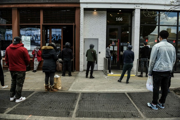 Customers waiting outside a restaurant for takeaway orders in Brooklyn, New York, on April 15