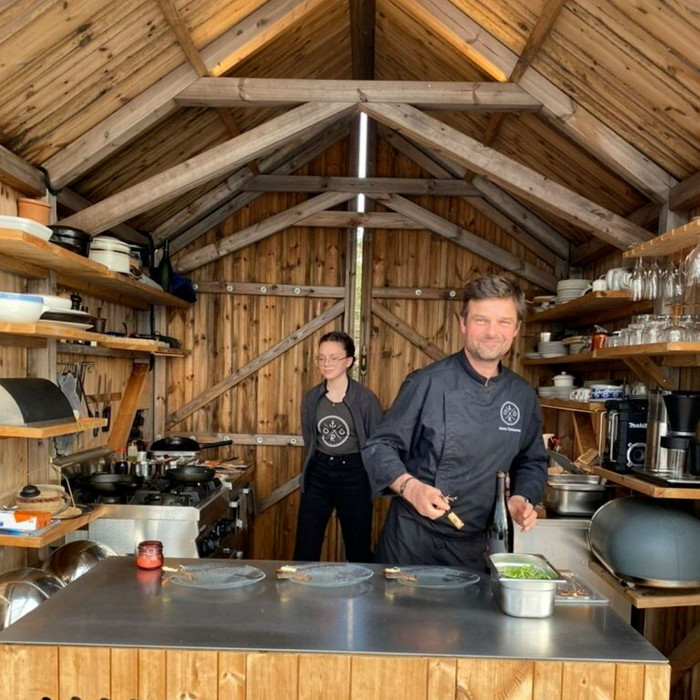 Chefs cooking in a cabin kitchen