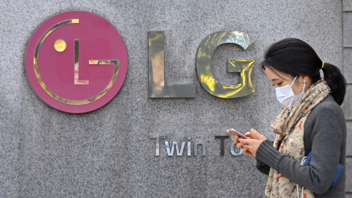 A woman walks in front of LG’s headquarters in Seoul 