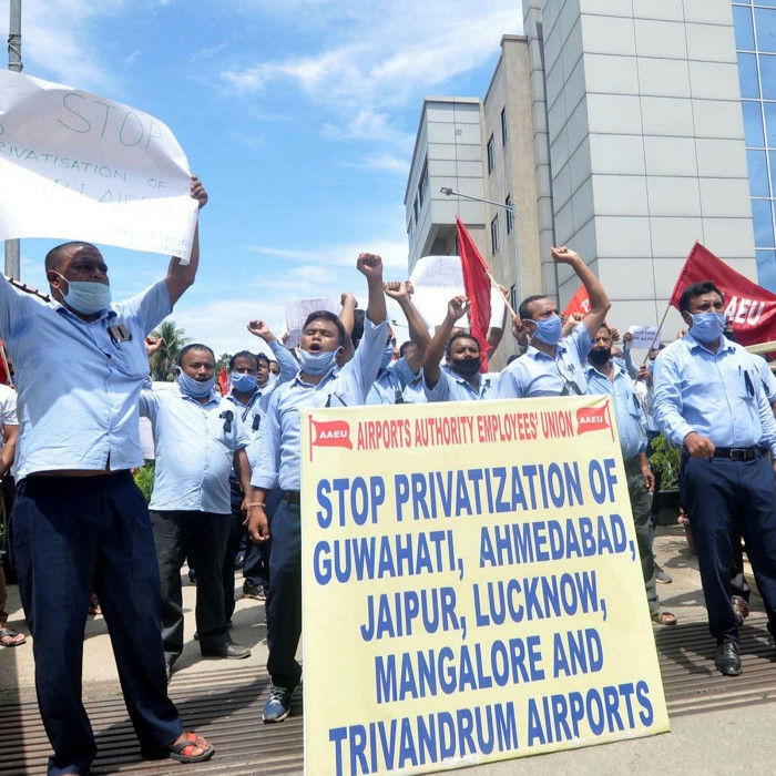 Members of Airport Authority Employees Union protest over the approval to lease three airports under the public-private partnership model, outside LGBI Airport in Guwahati