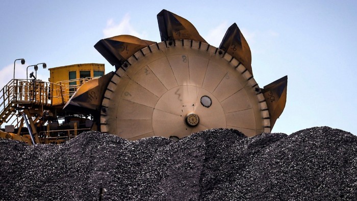 A bucket-wheel reclaimer next to a pile of coal in Australia, in October 2020