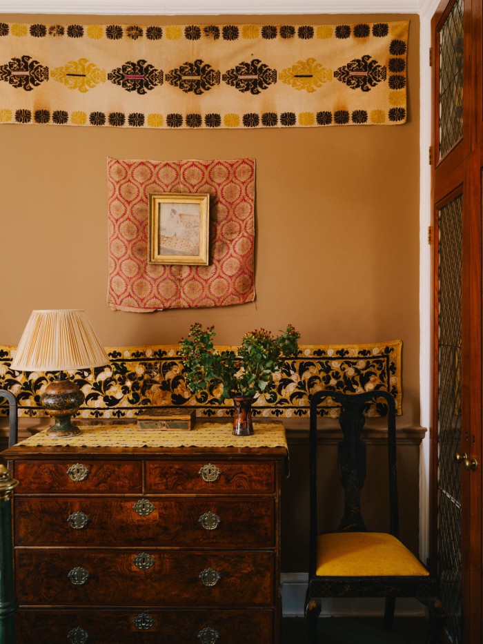 Renzullo’s antique-fabric collection includes (from top of wall) a 19th-century textile from the Dodecanese islands; an Ottoman 18th-century panel of silk lampas; and a fragment of Sicilian cut velvet on silk from the 18th century
