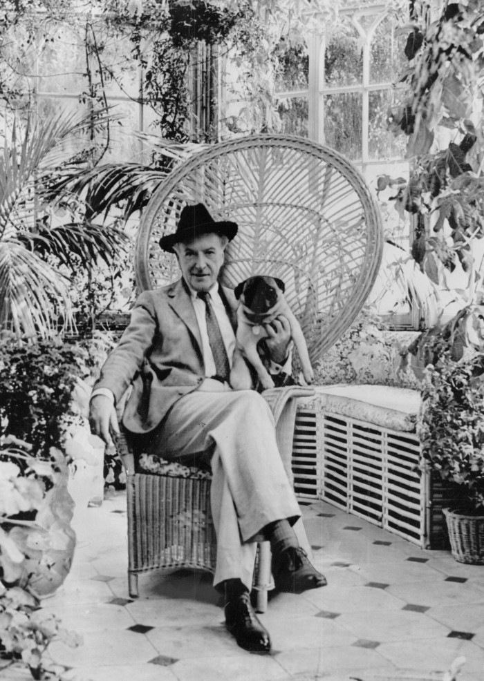 Cecil Beaton in his glasshouse at Reddish House in Wiltshire