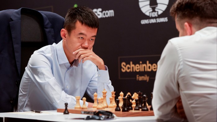 Chinese grandmaster Ding Liren looks deep in thought as he studies the chessboard facing his opponent