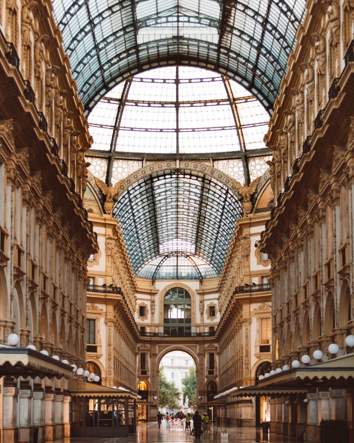 A part of the interior of the Galleria Vittorio Emanuele II, its 19th-century brownstone buildings reaching to its glass roof and dome