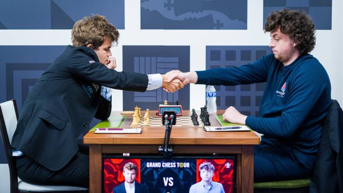 Magnus Carlsen faces Hans Niemann across the chess board