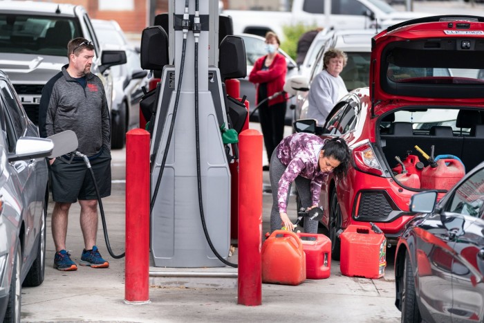 Motorists use gas pumps at a refuelling station