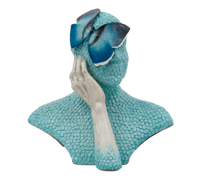 Ceramic bust of a person entirely covered in blue scales, except for a skeletal white hand touching their cheek