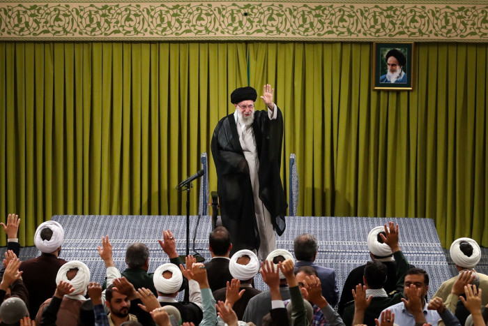 Ayatollah Ali Khamenei waves to a crowd
