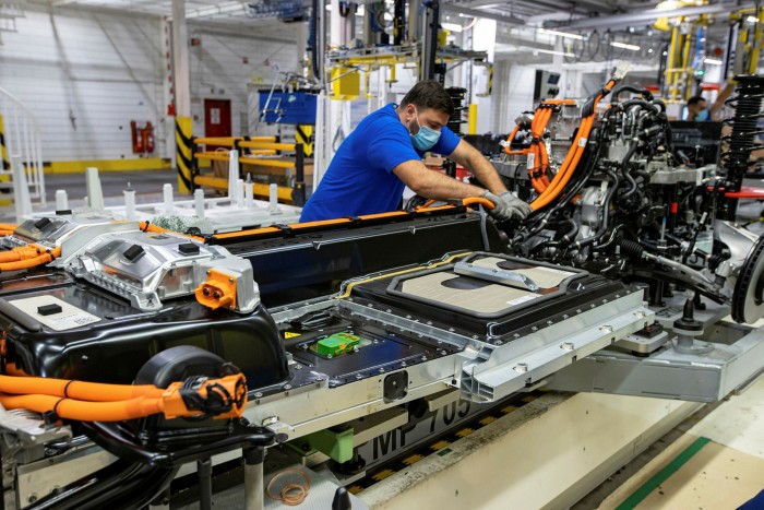 Man working on electric vehicle production line