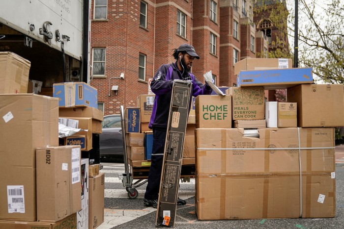 A delivery driver unloads boxes in  Washington. If a worker is classified as essential, they have few if any legal protections if they decide not to report for work