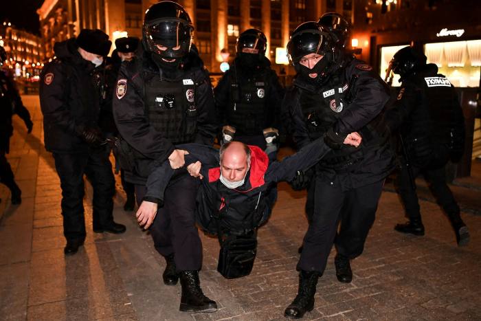 Police detain a protester at an anti-war demonstration in Moscow