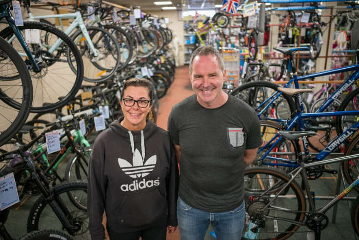 Two Richmond residents inside their cycle shop