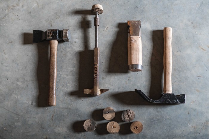 From left: a cooper’s hammer, used for driving bungs into casks, a bung extractor, a hoop driver for tightening hoops on casks, and a cooper’s adze, used for cutting the bungs flush to the stave