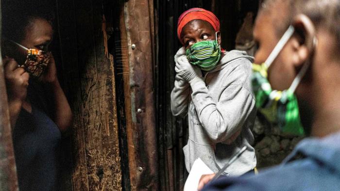 People learning to put on face masks in Nairobi