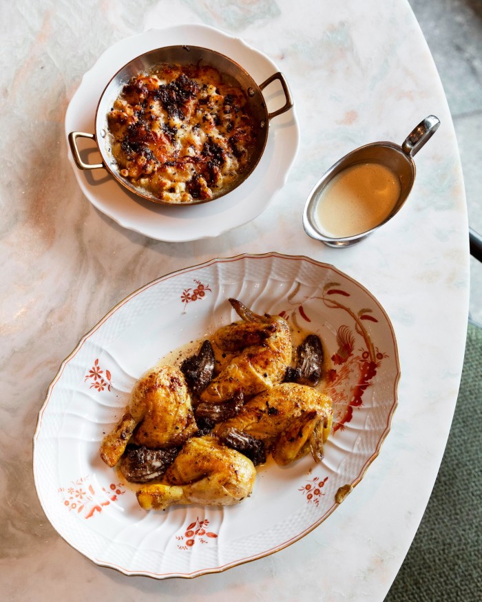 A plate of rotisserie poussin and a bowl of truffle mac and cheese 