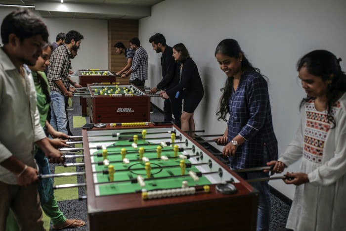 Employees play table-football during their lunch break at the Amazon.com office campus in Hyderabad, India, in September 2019