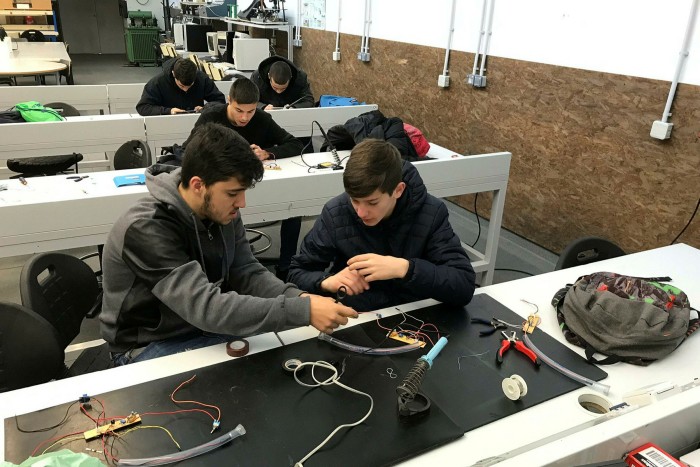 Students in a shop constructing devices 
